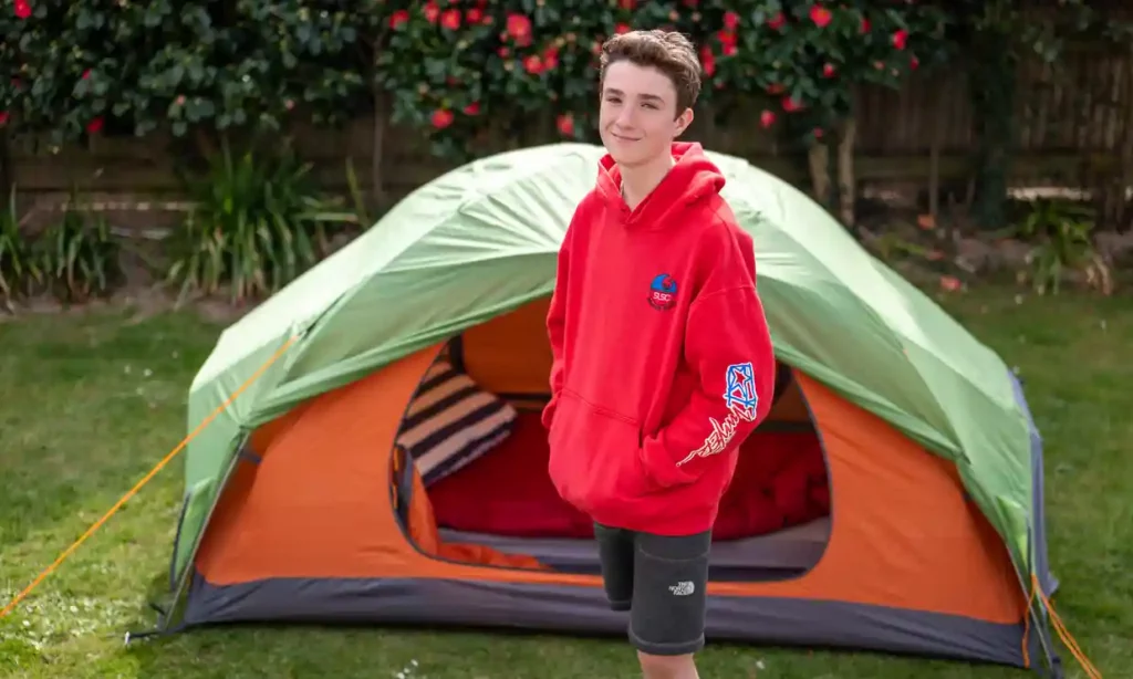 Max standing next to his tent